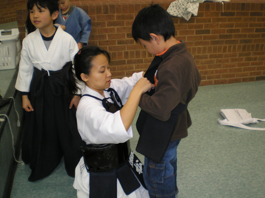 My friend, Matsumoto Sensei, helping the kids with their kendo gear