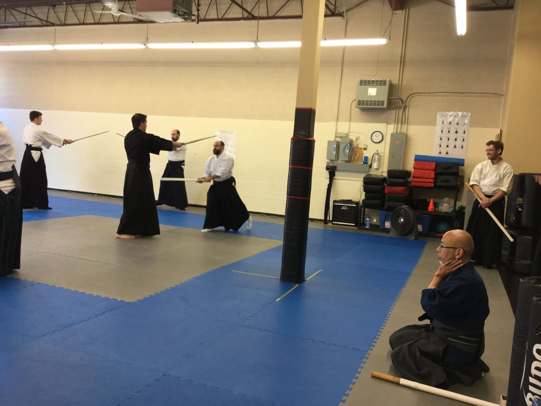 Sensei watching carefully how the students perform the kata